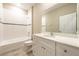 Bathroom with white vanity, tub, and tile shower surround at 5919 Sw 124Th Terrace Rd, Ocala, FL 34481