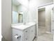 White bathroom vanity with quartz countertop and mirror at 5919 Sw 124Th Terrace Rd, Ocala, FL 34481