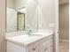 White bathroom vanity with quartz countertop and mirror at 5919 Sw 124Th Terrace Rd, Ocala, FL 34481