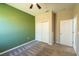 Bedroom with green accent wall, ceiling fan and double door closet at 5919 Sw 124Th Terrace Rd, Ocala, FL 34481