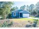 Newly built home with blue exterior, white trim, and two-car garage at 5919 Sw 124Th Terrace Rd, Ocala, FL 34481