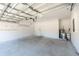 Garage with high ceiling, automatic opener and concrete floor at 5919 Sw 124Th Terrace Rd, Ocala, FL 34481