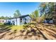 Rear view of house with blue exterior, and a large backyard at 5919 Sw 124Th Terrace Rd, Ocala, FL 34481