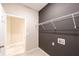 Laundry room with dark walls and wire shelving at 5919 Sw 124Th Terrace Rd, Ocala, FL 34481