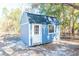 Blue storage shed with white trim and metal roof at 5919 Sw 124Th Terrace Rd, Ocala, FL 34481