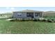 View of the backyard, including a covered lanai and landscaping at 8731 Sw 76Th Street Rd, Ocala, FL 34481