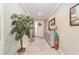 Bright and airy entryway with a console table and large plant at 8731 Sw 76Th Street Rd, Ocala, FL 34481