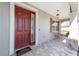 Elegant red front door with sidelights and a welcome mat at 8731 Sw 76Th Street Rd, Ocala, FL 34481