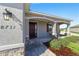 Inviting front porch with brick pavers and a charming red door at 8731 Sw 76Th Street Rd, Ocala, FL 34481