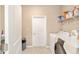 Convenient laundry room with washer, dryer, and shelving at 8731 Sw 76Th Street Rd, Ocala, FL 34481