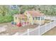 Yellow house with red steps and a white picket fence at 2605 W Silver Springs Blvd, Ocala, FL 34475