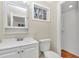 Clean bathroom with white vanity, toilet, and walk-in shower at 2605 W Silver Springs Blvd, Ocala, FL 34475