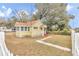 Quaint yellow house with sunroom and fenced yard at 2605 W Silver Springs Blvd, Ocala, FL 34475