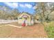 Yellow house exterior with a yard and white picket fence at 2605 W Silver Springs Blvd, Ocala, FL 34475