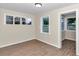 Bright room featuring hardwood floors and multiple windows at 2605 W Silver Springs Blvd, Ocala, FL 34475