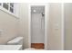 White tiled walk-in shower with wood-like flooring at 2605 W Silver Springs Blvd, Ocala, FL 34475