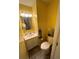 Small bathroom with white vanity and yellow walls at 11001 Se Sunset Harbor Rd # B09, Summerfield, FL 34491