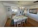 Bright dining room with white table and chairs, hardwood floors at 11001 Se Sunset Harbor Rd # B09, Summerfield, FL 34491