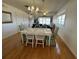 Charming dining room with lake view and hardwood floors at 11001 Se Sunset Harbor Rd # B09, Summerfield, FL 34491