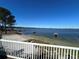 Stunning view of the lake from a deck with white railing at 11001 Se Sunset Harbor Rd # B09, Summerfield, FL 34491