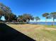 Expansive grassy area overlooking the lake at 11001 Se Sunset Harbor Rd # B09, Summerfield, FL 34491