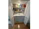 Bright laundry room with washer, dryer, and storage shelves at 11001 Se Sunset Harbor Rd # B09, Summerfield, FL 34491