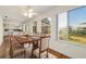 Sunlit dining room with hardwood floors and view of backyard at 11436 Sw 84Th Court Rd, Ocala, FL 34481