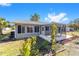 House exterior showcasing a screened porch and landscaping at 11436 Sw 84Th Court Rd, Ocala, FL 34481