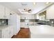 Galley kitchen with white cabinets, laminate counters, and tile backsplash at 11436 Sw 84Th Court Rd, Ocala, FL 34481