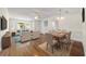 Living room with hardwood floors, staged furniture, and a dining area at 11436 Sw 84Th Court Rd, Ocala, FL 34481