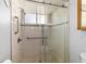 Walk-in shower with grab bars and tiled walls at 11436 Sw 84Th Court Rd, Ocala, FL 34481