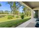 Enjoy serene golf course views from this covered patio at 141 Hickory Course Cir, Ocala, FL 34472