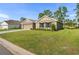 Two-car garage and front yard with landscaping at 141 Hickory Course Cir, Ocala, FL 34472