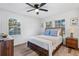 Cozy bedroom with wood-toned furniture and ceiling fan at 7874 Midway Drive Ter # V201, Ocala, FL 34472