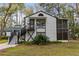 Charming white two-story home with a black trim and screened porch at 7874 Midway Drive Ter # V201, Ocala, FL 34472