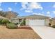 One-story house with a white garage door and landscaped yard at 8036 Sw 78Th Terrace Rd, Ocala, FL 34476