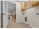 Well-lit laundry room with built-in cabinets and shelving at 8036 Sw 78Th Terrace Rd, Ocala, FL 34476