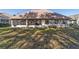 Rear view of the house featuring a screened patio, windows, and exterior plants at 11031 Sw 69Th Cir, Ocala, FL 34476