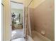 Bathroom shows a shower-tub combo, colorful curtains and a view into the adjacent bonus room at 11031 Sw 69Th Cir, Ocala, FL 34476