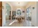 Bright breakfast nook bathed in natural light features a view of the backyard and an elegant chandelier at 11031 Sw 69Th Cir, Ocala, FL 34476