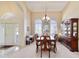 Elegant dining room with high ceilings, large windows, chandelier and plenty of natural light at 11031 Sw 69Th Cir, Ocala, FL 34476