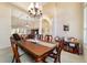 Elegant dining room with chandelier and seamless connection to living area at 11031 Sw 69Th Cir, Ocala, FL 34476