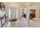 Inviting foyer with tile flooring, high ceilings, decorative lighting, and arched doorway at 11031 Sw 69Th Cir, Ocala, FL 34476