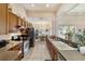Functional kitchen with wood cabinets, long countertop, and seamless view to the dining area at 11031 Sw 69Th Cir, Ocala, FL 34476