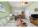 Bright living room with comfortable seating, built-in shelving, and a television at 11031 Sw 69Th Cir, Ocala, FL 34476