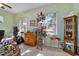 Cozy living room with large windows providing ample sunlight and serene outdoor views at 11031 Sw 69Th Cir, Ocala, FL 34476