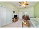 Comfortable living room features a ceiling fan, carpet flooring and neutral paint at 11031 Sw 69Th Cir, Ocala, FL 34476