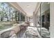 Screened-in patio offers a relaxing outdoor space with views of the lush greenery and mature trees at 11031 Sw 69Th Cir, Ocala, FL 34476