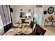 Dining room with a wooden table and chairs, looking into kitchen at 1326 Spring Lite Way, Orlando, FL 32825