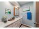 Guest bathroom with white vanity and a large mirror at 3261 Se 32Nd St, Ocala, FL 34471